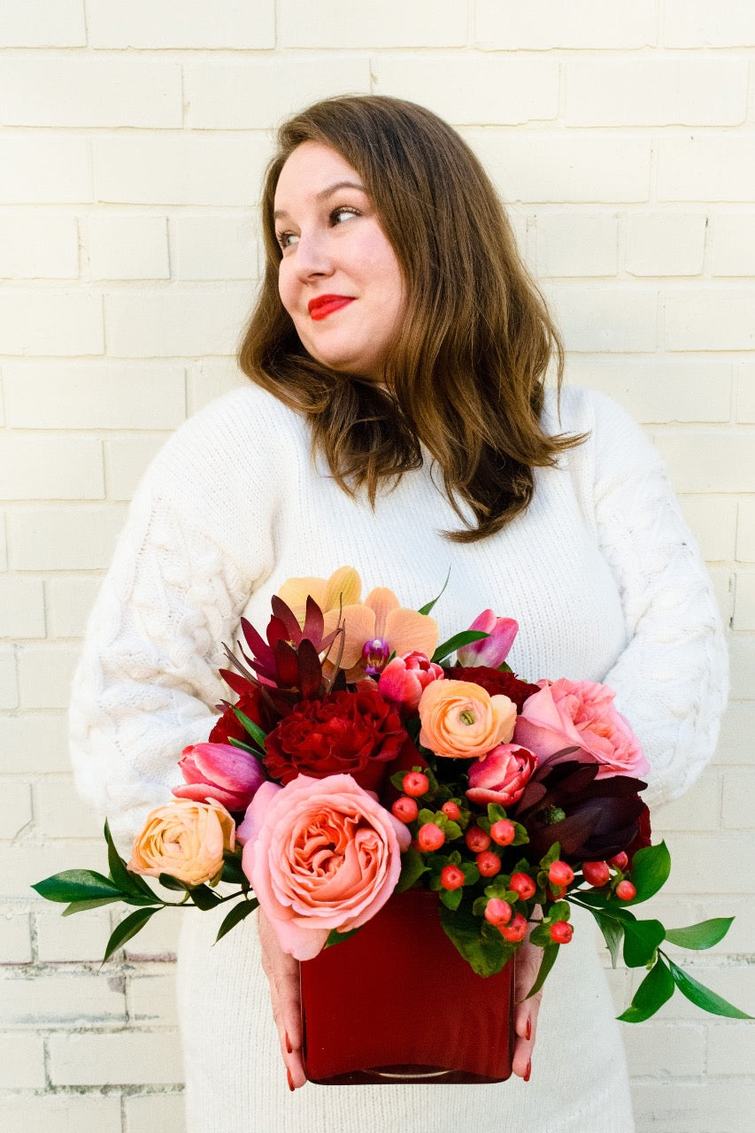 Mixed flower arrangement of garden roses, ranunculus and berries