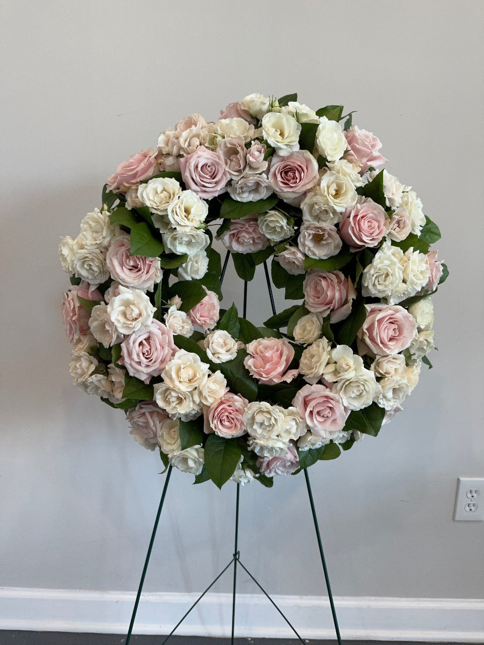 Floral sympathy wreath on easel