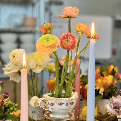 Flowers arranged in a tea cup
