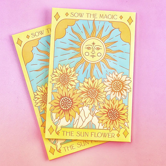 A set of brightly colored envelopes with a tarot card design featuring the sun and a flower, titled 'The Sunflower'. The envelopes are adorned with images of sunflowers and a crescent moon.