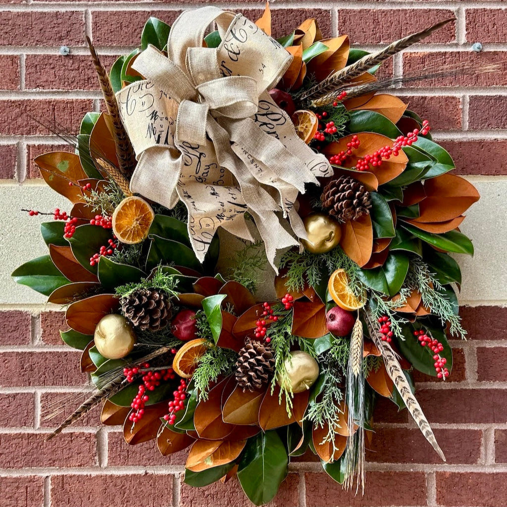 Decorative wreath with textured elements on a brick wall