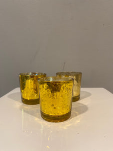 A trio of gold mercury glass votive candle holders. Candles are included with purchase.