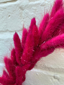 Closeup view of Hot Pink Bunny Tail Wreath, finished with matched satin bow