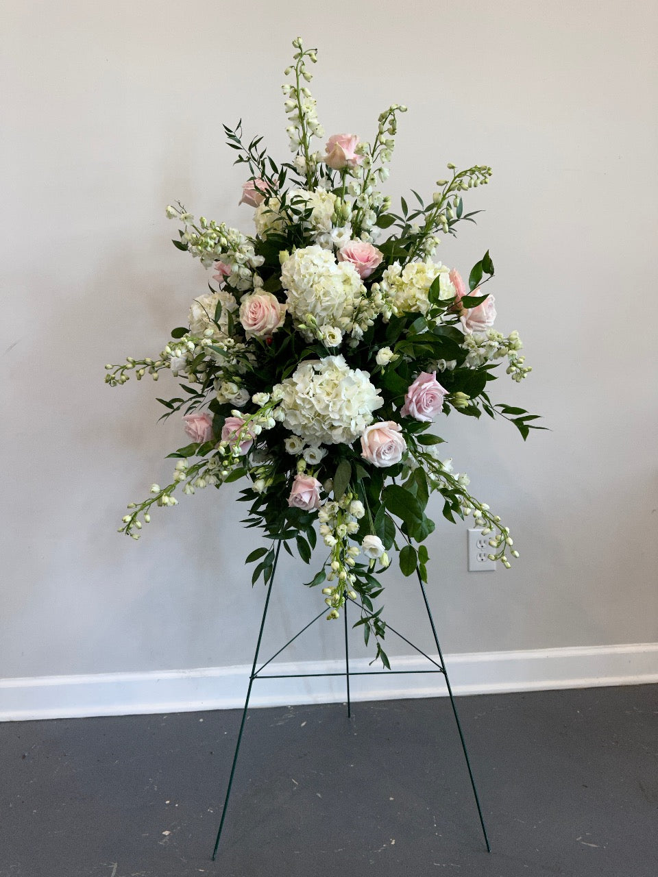 Funeral spray on easel