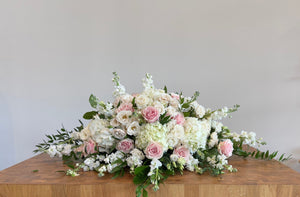 Casket flowers featuring hydrangea and roses