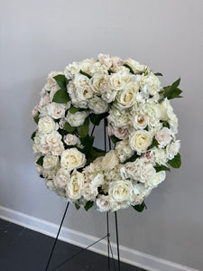 Floral wreath for sympathy on easel